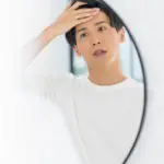 鏡を見る男性