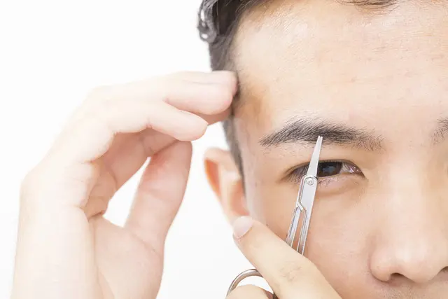 眉を整える男性