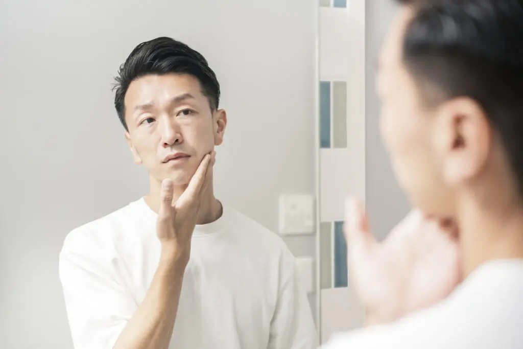 鏡を見る男性