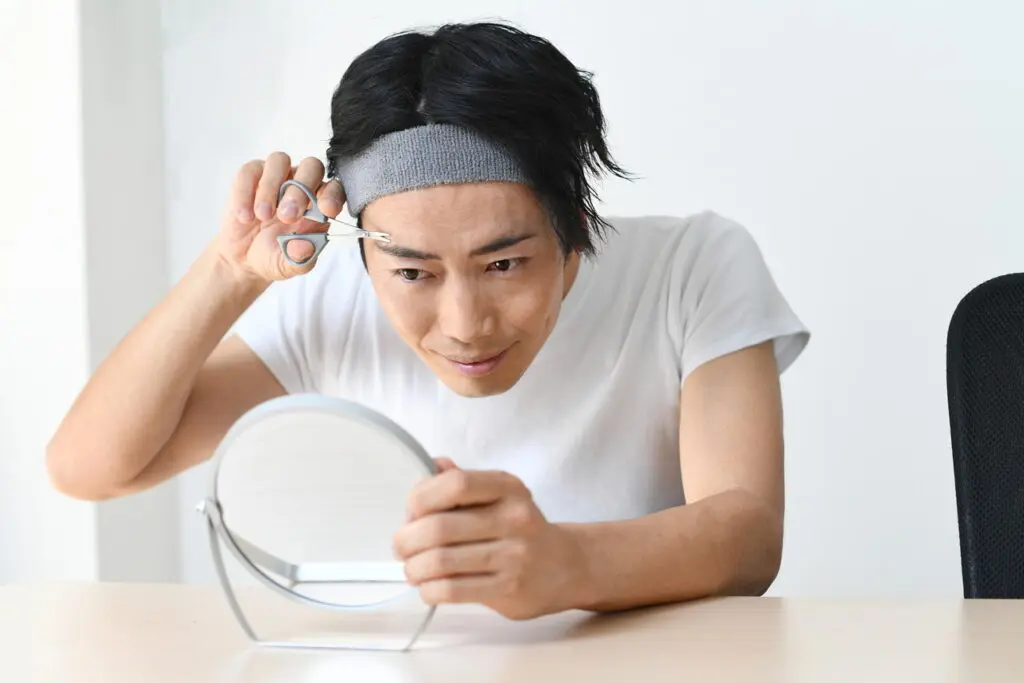 眉毛を手入れする男性